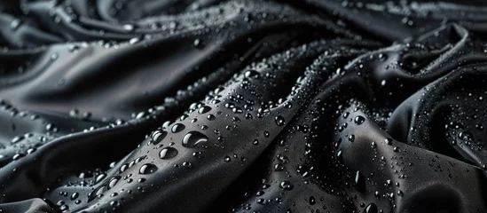 Fotobehang Lotus effect with water drops on black textile. Creative Banner. Copyspace image © HN Works