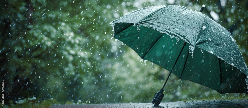 Aufkleber broken green umbrella in park on rainy day with hail. creative banner. copyspace image