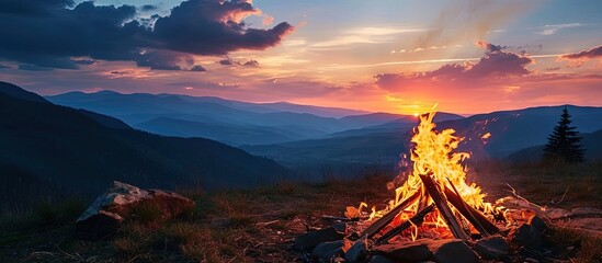 Bonfire on a background of the sky in the mountains. Creative Banner. Copyspace image