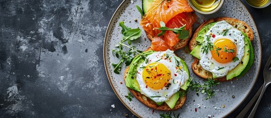 Healthy food avocado and red fish salmon toast sandwich for breakfast or keto dieting top view. Creative Banner. Copyspace image - obrazy, fototapety, plakaty