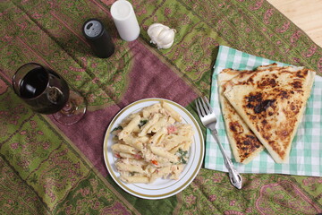 Plate of Pasta Carbonara With Italian Flat Bread on Rustic Table