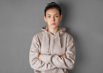 Pensive thoughtful young girl wearing sweatshirt with hood