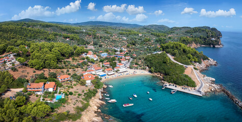 Panoramic aerial view to the idyllic fishing village of Katigiorgis, South Pelion, Greece, with turquoise, clear sea