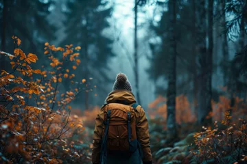 Fototapeten Adventurous soul in a warm jacket ventures into a foggy forest, the autumn colors enhancing the mystery and exploration theme.   © Kishore Newton