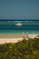 Paradise Cove: Small Boat and Pier in Turquoise Waters in australia