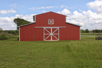 Classic Red Barn on Green Grass With Blue Sky. Rural East Texas