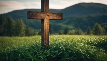  a wooden cross sitting in the middle of a grass covered field with a mountain range in the distance in the distance is a field of green grass, with trees, and mountains in the foreground.