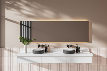 Beige hotel bathroom interior with double sink and minimalist accessories