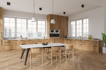 Stylish home kitchen interior with cooking and eating space, panoramic window