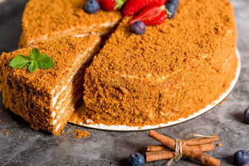 Honey cake. Homemade baking concept. Slit and slice of cake. Homemade layered honey cake
