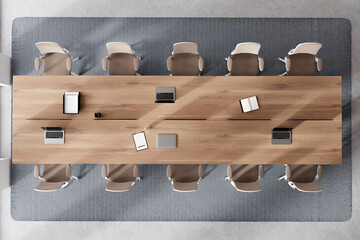 Top view of office meeting room interior with table and armchairs, laptop