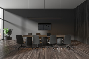 Grey meeting interior with table and chairs, tv display and panoramic window