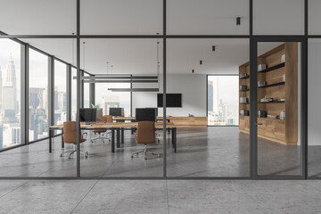 Glass coworking interior with desk and pc desktop in row, panoramic window