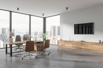 Corner view of office interior with work desk near window, pc desktop and drawer - obrazy, fototapety, plakaty