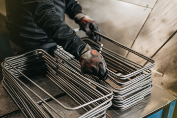 Worker holding reinforcement steel with gloves
