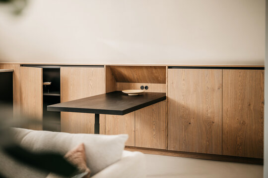 Modern living room with oak wood colors and a black kitchen table