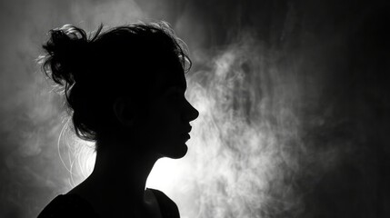 Silhouette of a person against a monochromatic background, creating a mysterious mood