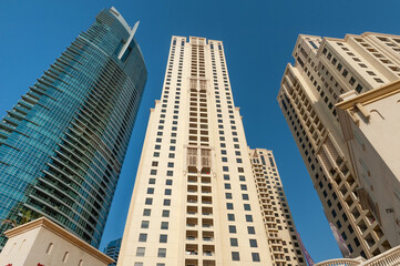 Fototapeta na wymiar Modern skyscraper apartment complex buildings on the sea front, Dubai, United Arab Emirates. .