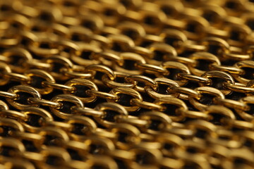 Close-up of intricate golden chain links with a gleaming metallic finish.