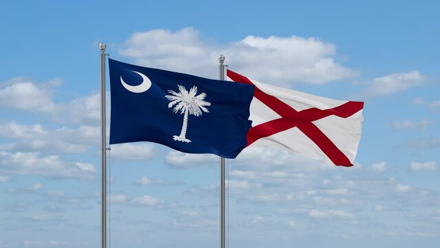 Alabama and South Carolina US state flags waving together on cloudy sky, endless seamless loop