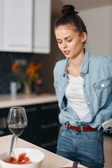 Fashionable, Sensual Woman Enjoying a Glass of Red Wine at Home, Curly Hair and Elegant Beauty