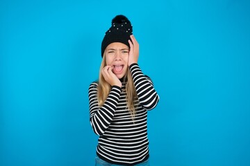 Doleful desperate crying caucasian teen girl , looks stressfully, frowns face, feels lonely and anxious