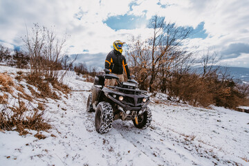 A young adventurous couple embraces the joy of love and thrill as they ride an ATV Quad through the...