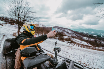 A couple enjoys an adventurous quad ride through the snowy landscape, capturing the thrill of the...