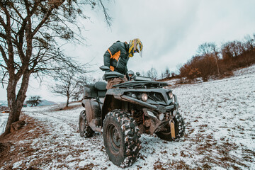  An adventurous couple prepares for an exhilarating quad ride through the forest, embodying...