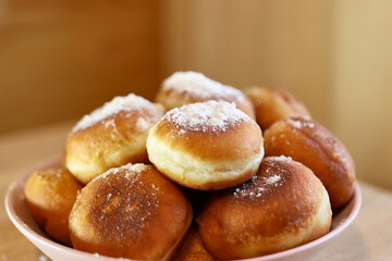 Fresh, ruddy donuts with a sweet filling, sprinkled with sugar.