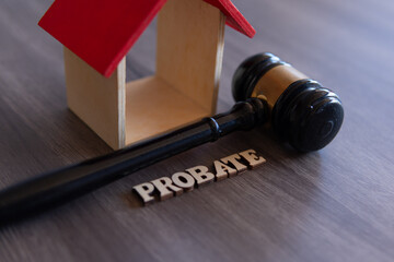Closeup image of judge gavel, wooden house and word PROBATE. Copy space for text.