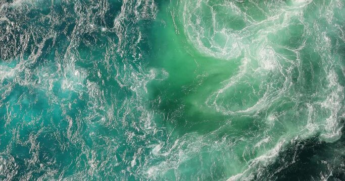 Blue waves of water of the river and the sea meet each other during high tide and low tide.