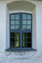 Old wood framed window on a stone building.