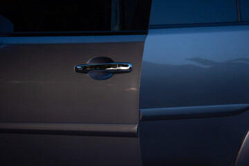 Door of car grey color is open. Atmosphere of the evening light is gloomy.