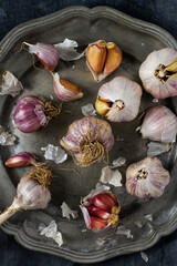 Raw garlic on grey pewter plate