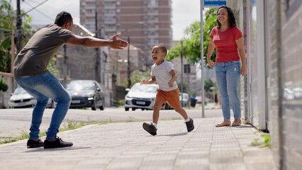 Divorced couple sharing custody of children. Father returning son to his mom after weekend. Shared...
