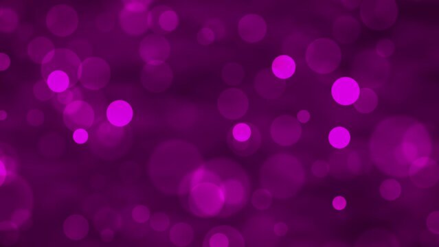 Purple glowing bokeh particles animation.Purple background.Moving bubbles colorful blurred animation backdrop.christmas and valentine's day background.