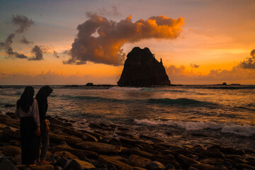 Sunset at the rocky beach in Papuma, Jember, East Java, Indonesia - obrazy, fototapety, plakaty