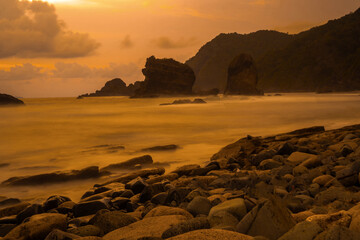 Sunset at the rocky beach in Papuma, Jember, East Java, Indonesia