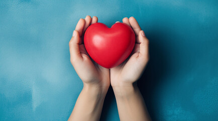 Obraz premium The essence of love with hands presenting a red heart on a serene blue background, an eloquent symbol of affection. Generative AI.