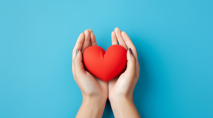 Fototapeta premium The essence of love with hands presenting a red heart on a serene blue background, an eloquent symbol of affection. Generative AI.