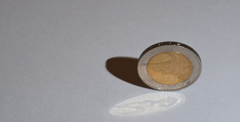 Den Helder, Netherlands. November 2023. A two Euro coin with a double shadow.