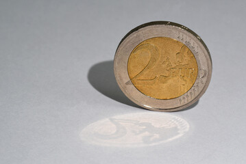 Den Helder, Netherlands. November 2023. A two Euro coin with a double shadow.