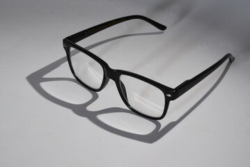 Den Helder, Netherlands. November 2023. A pair of glasses with shadow on white background.