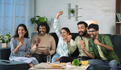Group of young sport fan celebrating win while watching live cricket match on television at home - concept of weekend entertainment, championship and friendship. - obrazy, fototapety, plakaty