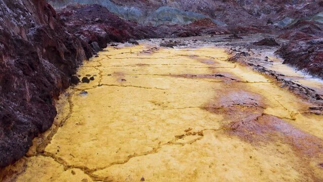 Sulfur stream after rare raine, dropped, supersaturated solutions, chemical fluvial sediments, Mountains of volcanic origin. Hormuz Island, Iran