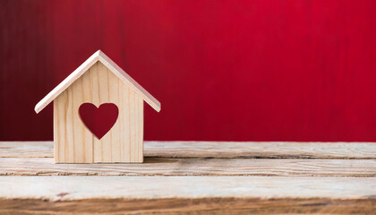House wood with heart shape on wooden and red background, copy space