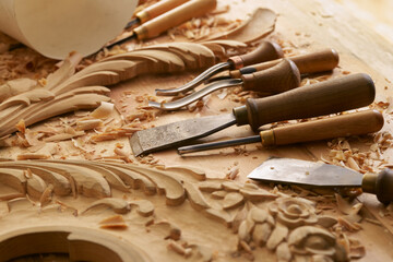 Carpenter. Wood carving close-up photo. Wooden engraving