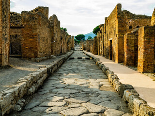 Amazing stone alley in the ancient city of Pompeii with ruins of old buildings on both sides, Naples, Italy
- 700657773
