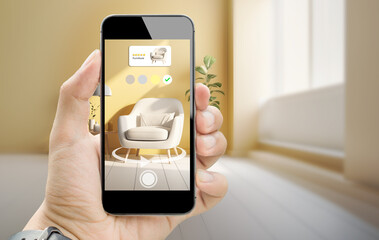 augmented reality for smart Business furniture interior design concept.Man hands holding mobile phone on blurred living room as background - obrazy, fototapety, plakaty